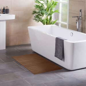 Badezimmer mit modernem Design, in dem ein rechteckiger Bambus-Badteppich in Taupe vor einer weißen Badewanne liegt, neben einem Waschbecken und einer Zimmerpflanze.