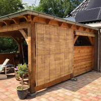 Holzhütte mit großem Bambusrollo, das als Sonnen- und Sichtschutz dient. Naturfarbene Bambusjalousie, ideal für Fenster und Türen, bietet eine stilvolle und ökologische Lösung für den Außenbereich.