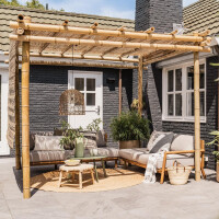 Bambus Pergola mit natürlichem Design, die einen gemütlichen Outdoor-Bereich mit Sitzgelegenheiten und Dekoration schafft. Die stabile Struktur aus Bambusstäben bietet Schatten und stilvolle Akzente für jeden Garten.